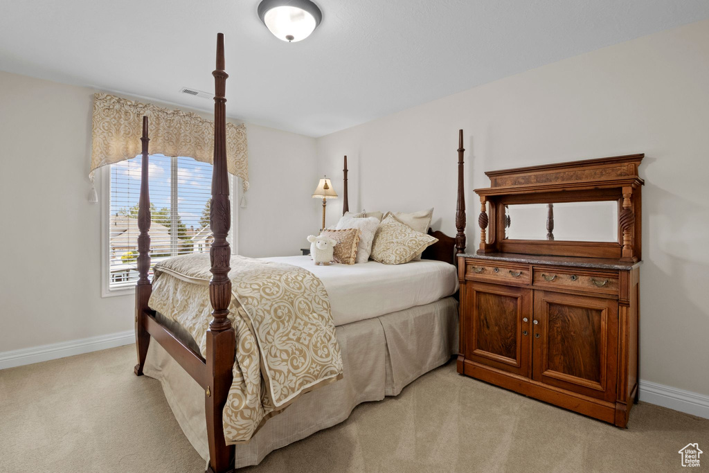 Bedroom with light carpet and baseboards