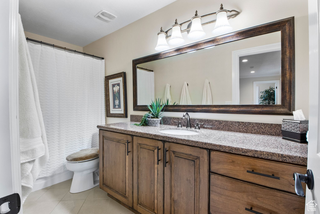 Full bath featuring tile patterned floors, vanity, and a shower with shower curtain