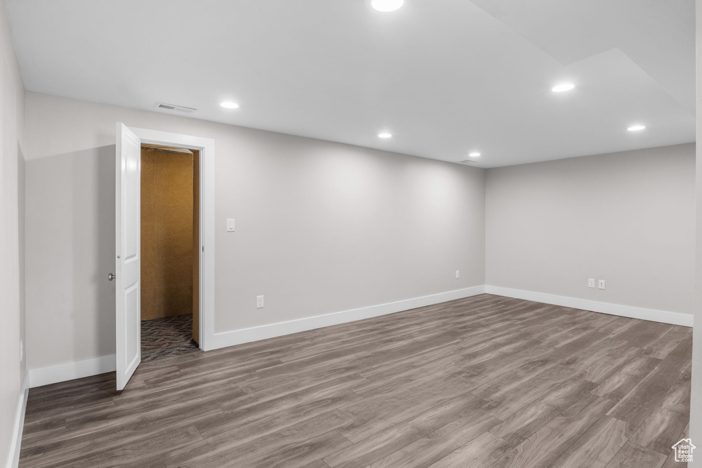 Spare room with wood finished floors and recessed lighting