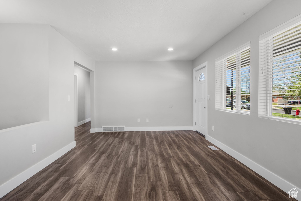 Unfurnished room featuring dark wood-type flooring and recessed lighting