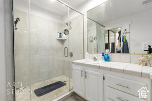 Bathroom with vanity and a shower stall