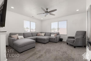 Living room with ceiling fan, carpet, and recessed lighting