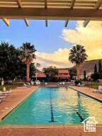 Pool at dusk featuring a community pool