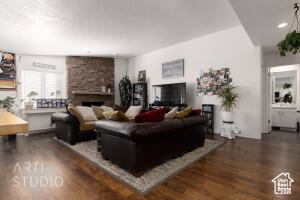 Living area featuring a large fireplace and wood finished floors