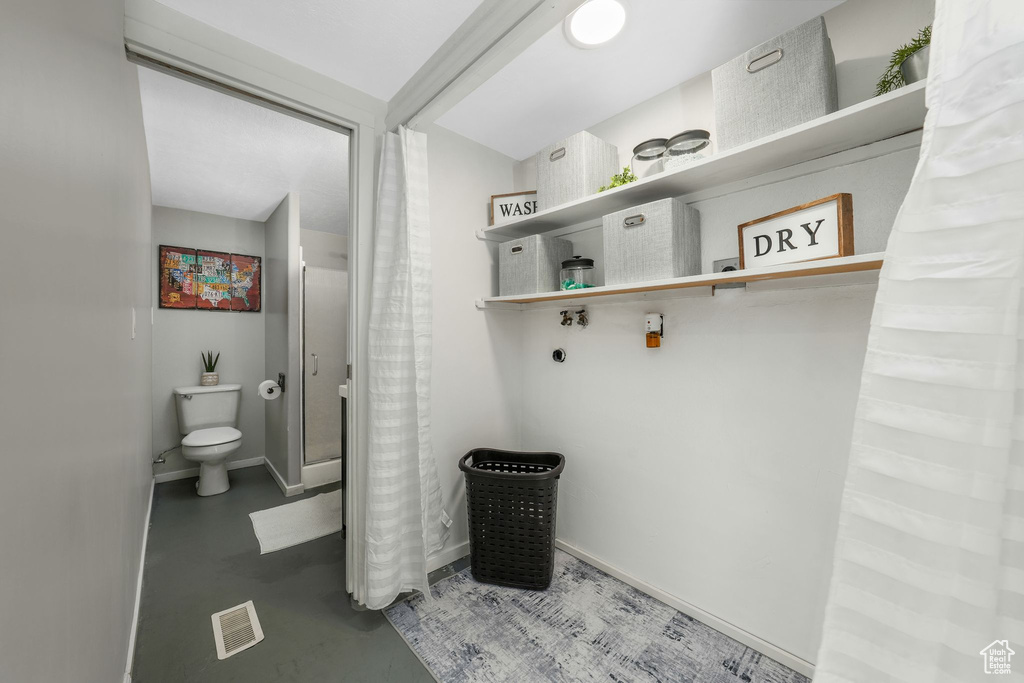 Bathroom with finished concrete floors and toilet