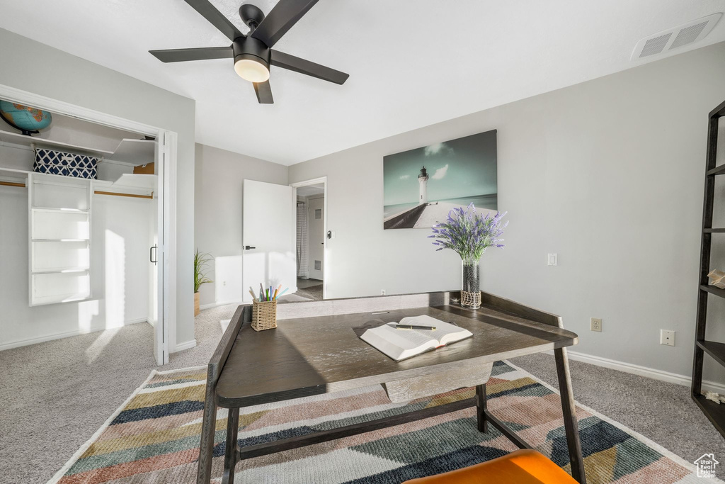 Home office with carpet floors and a ceiling fan