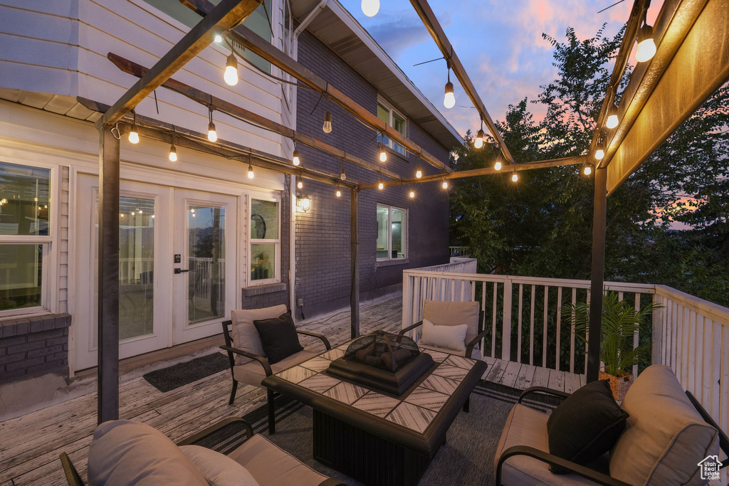 Deck with french doors and an outdoor living space with a fire pit