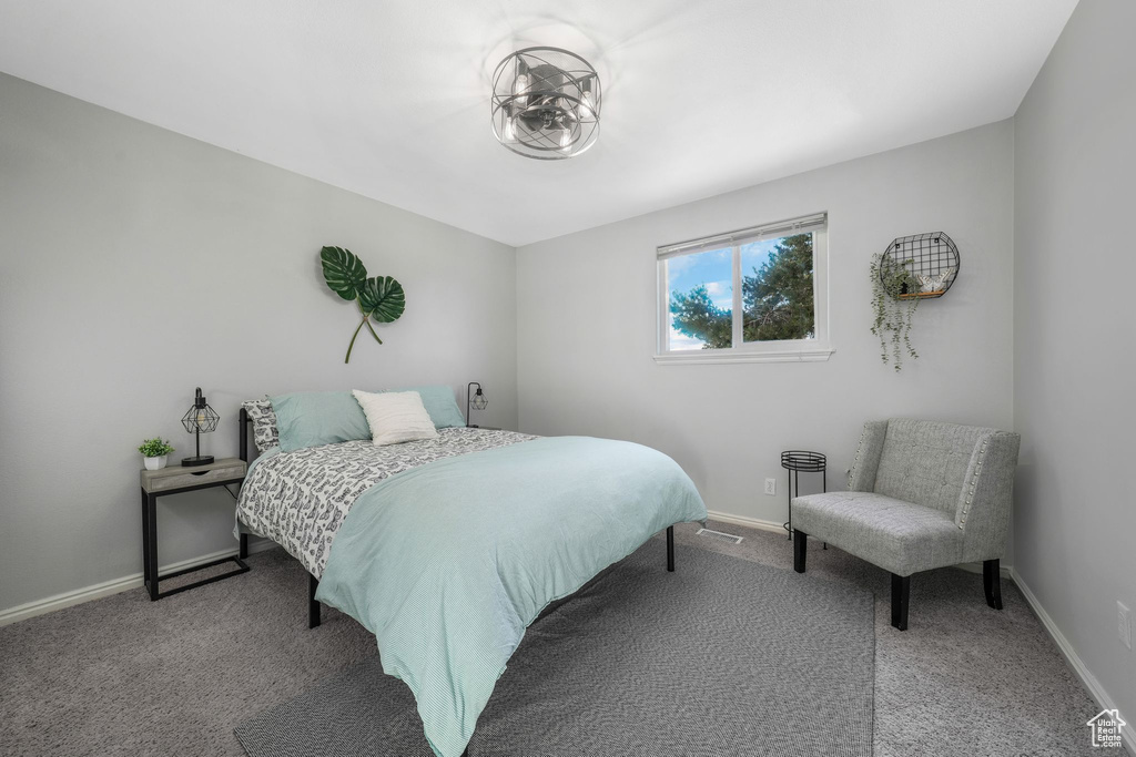 Bedroom with carpet flooring and baseboards