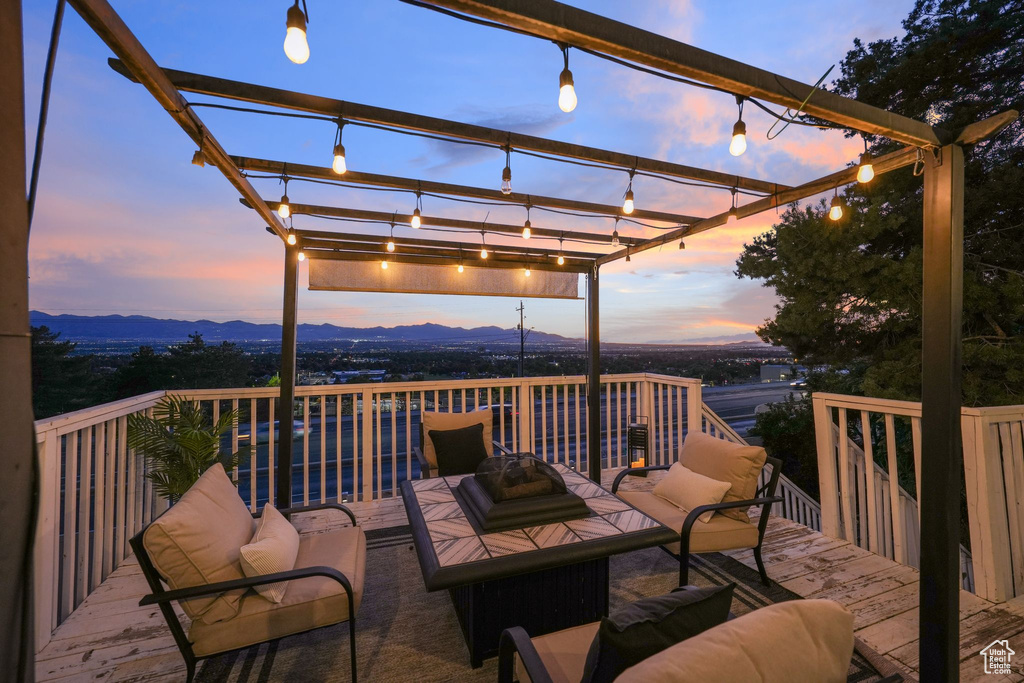 Wooden terrace with a pergola, a mountain view, and an outdoor living space