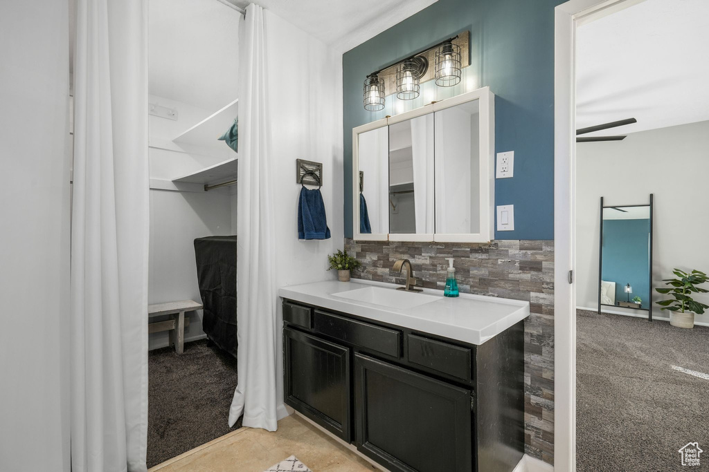 Bathroom featuring backsplash and vanity