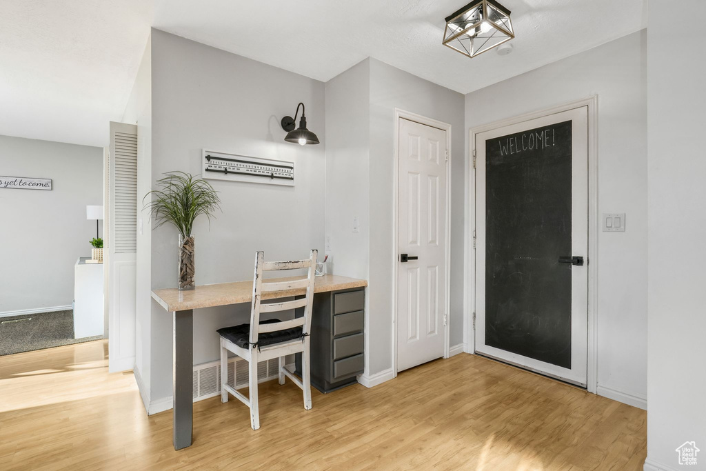 Office area with light wood-style floors