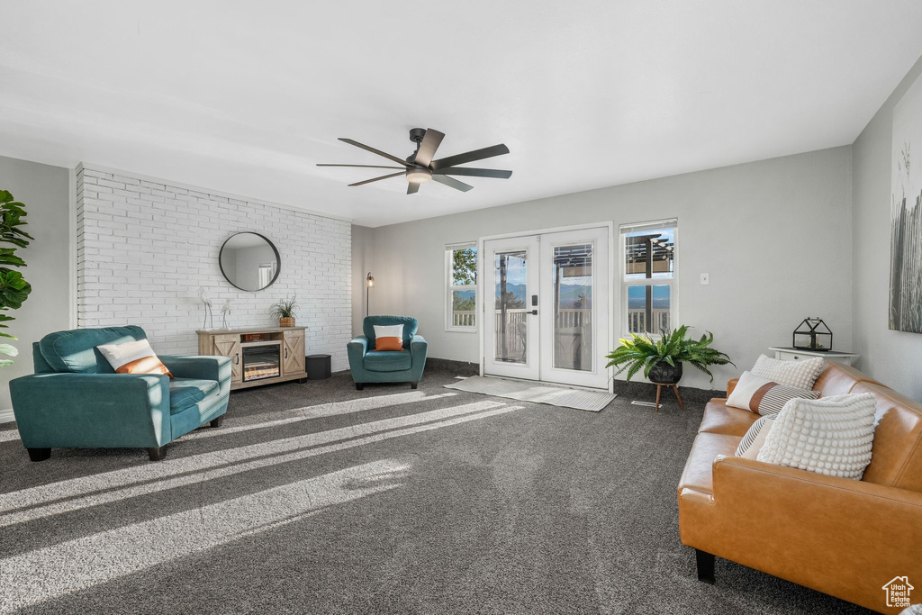 Living area with french doors, carpet, and ceiling fan