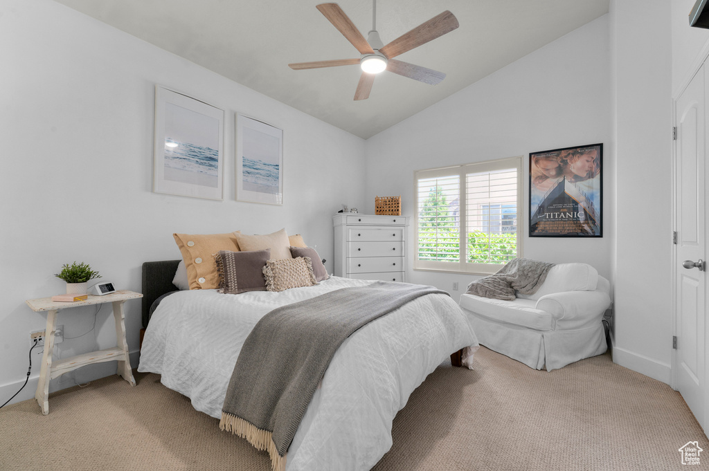 Carpeted bedroom with lofted ceiling and a ceiling fan