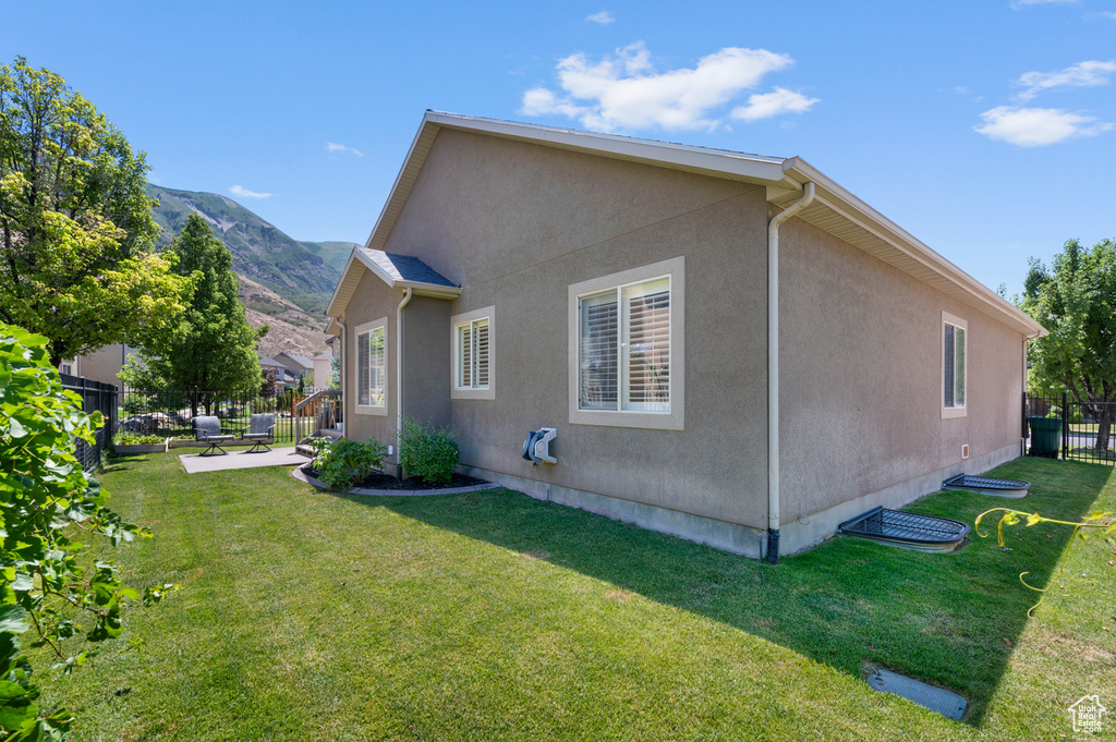 View of home\'s exterior featuring stucco siding, a patio area, and a mountain view