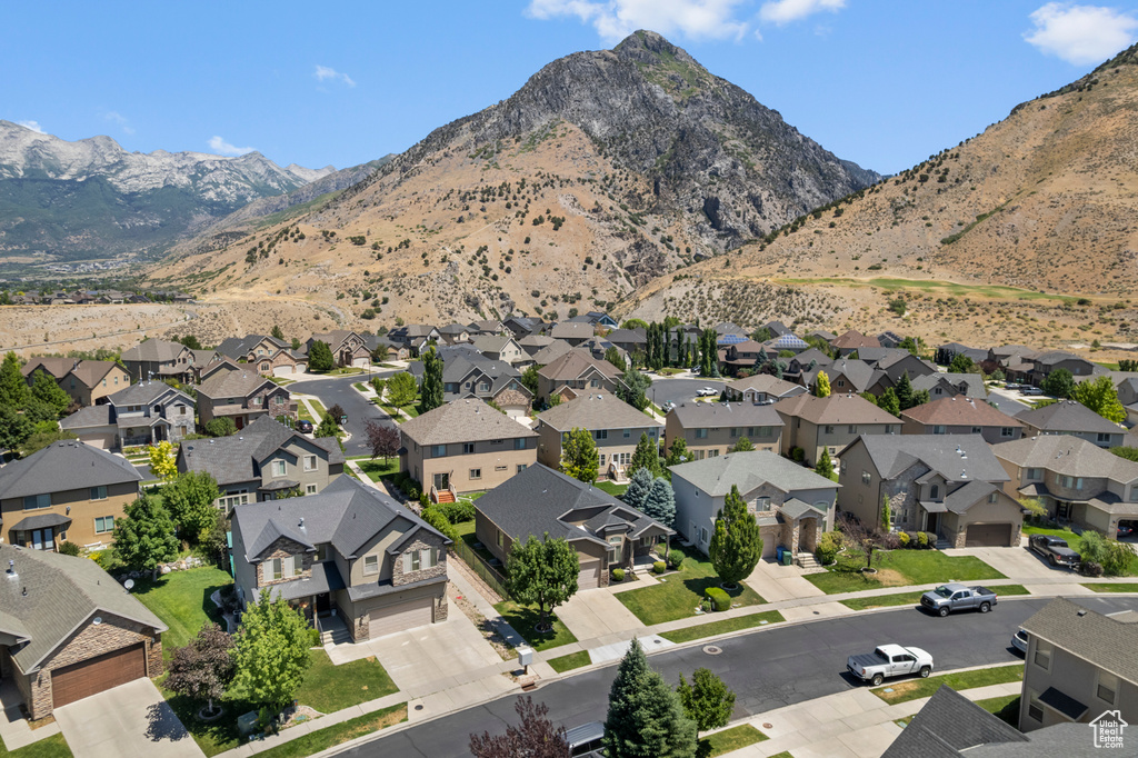 Aerial view of property and surrounding area with mountains and nearby suburban area