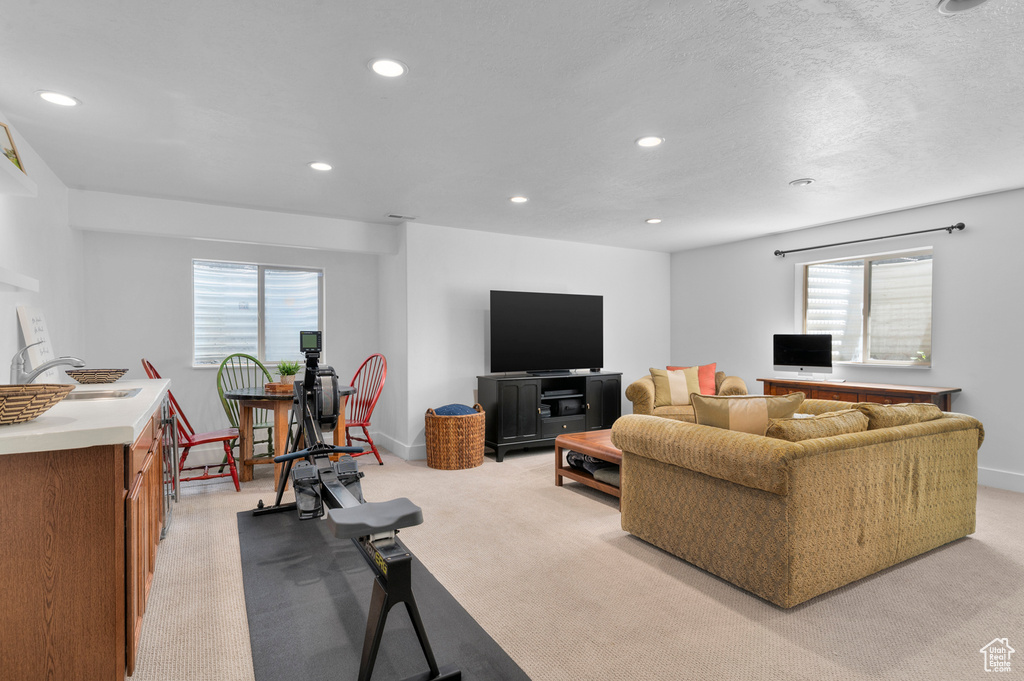Living room with recessed lighting and light colored carpet