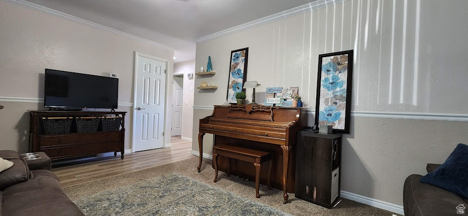 Living room featuring crown molding and baseboards