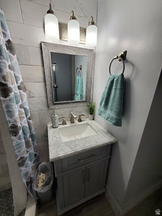 Bathroom featuring vanity and curtained shower