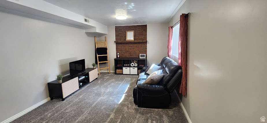 Living area featuring carpet floors and baseboards