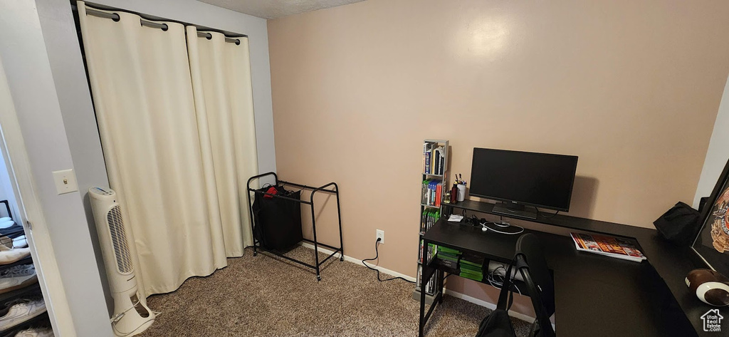 Carpeted office space featuring baseboards