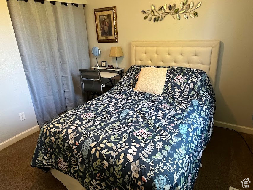 Carpeted bedroom with baseboards