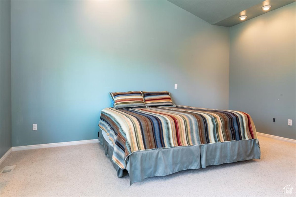 Bedroom featuring carpet and baseboards