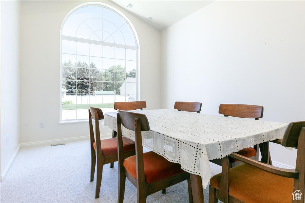 Dining area featuring baseboards and carpet flooring