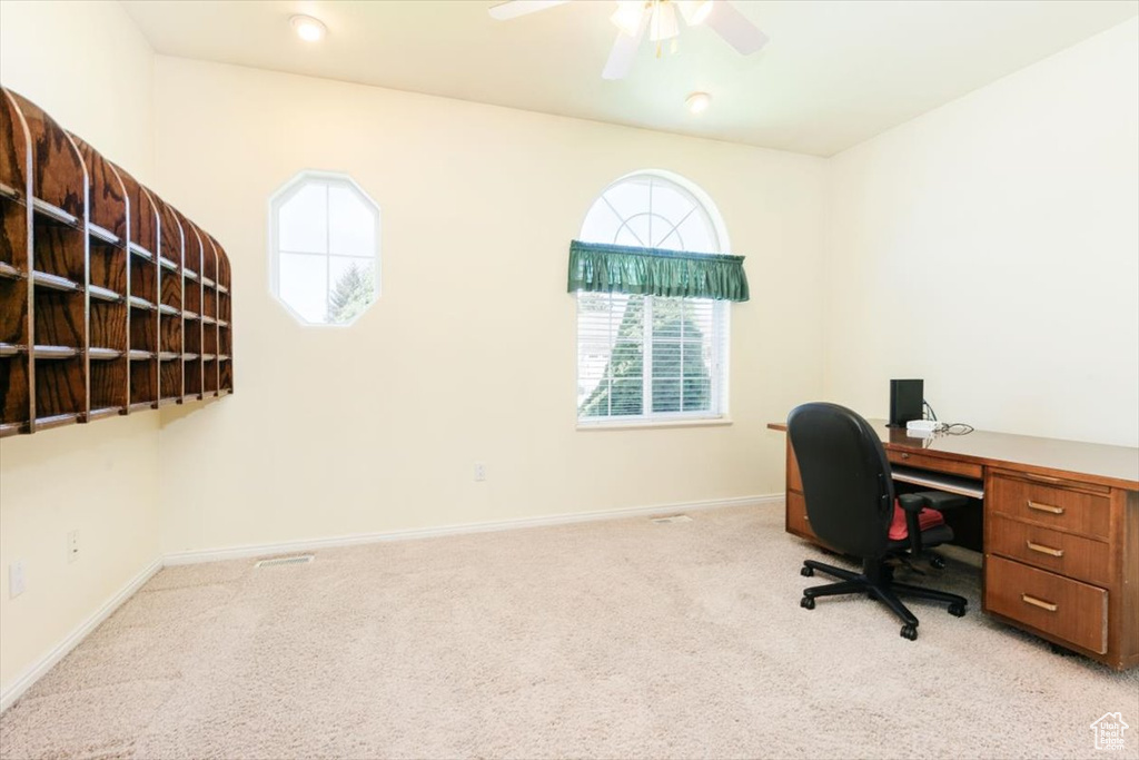Office area with carpet and ceiling fan