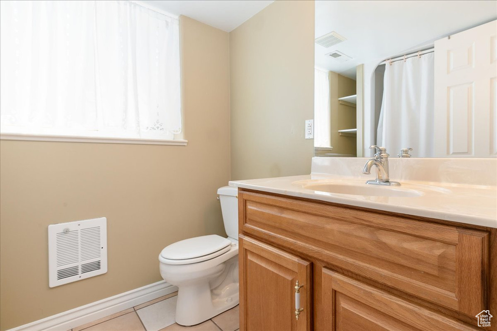 Full bathroom with vanity, tile patterned flooring, and heating unit