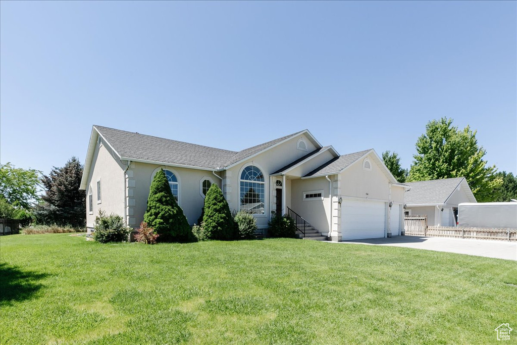 Ranch-style home featuring concrete driveway, stucco siding, and a garage