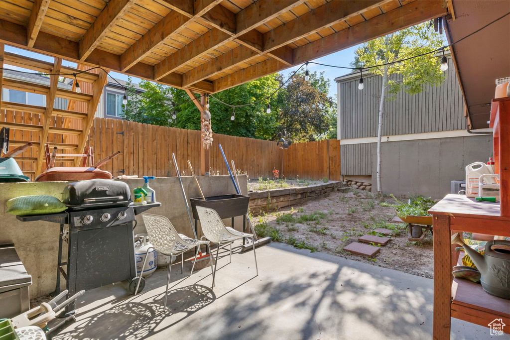Fenced backyard featuring a patio and area for grilling