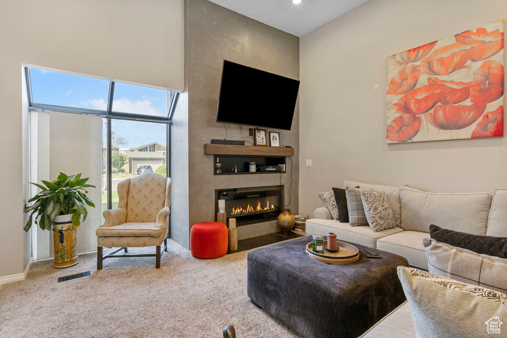 Carpeted living room featuring a fireplace