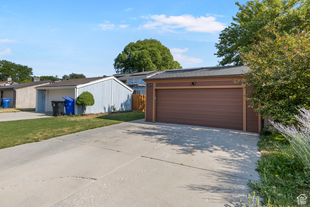Garage featuring concrete driveway