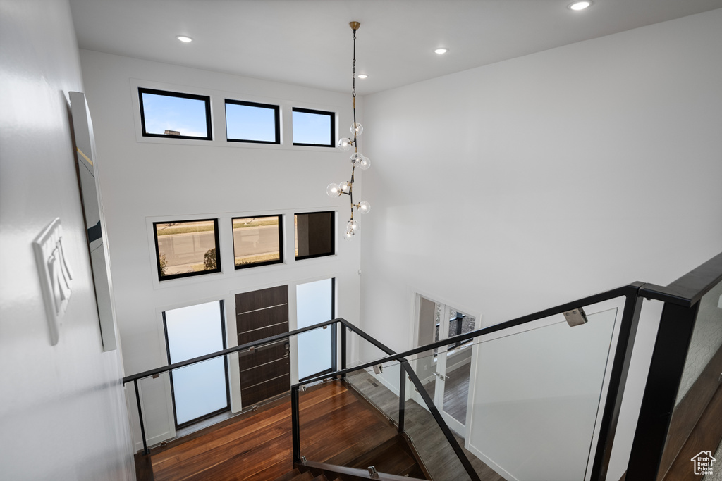 Stairway with wood finished floors and recessed lighting