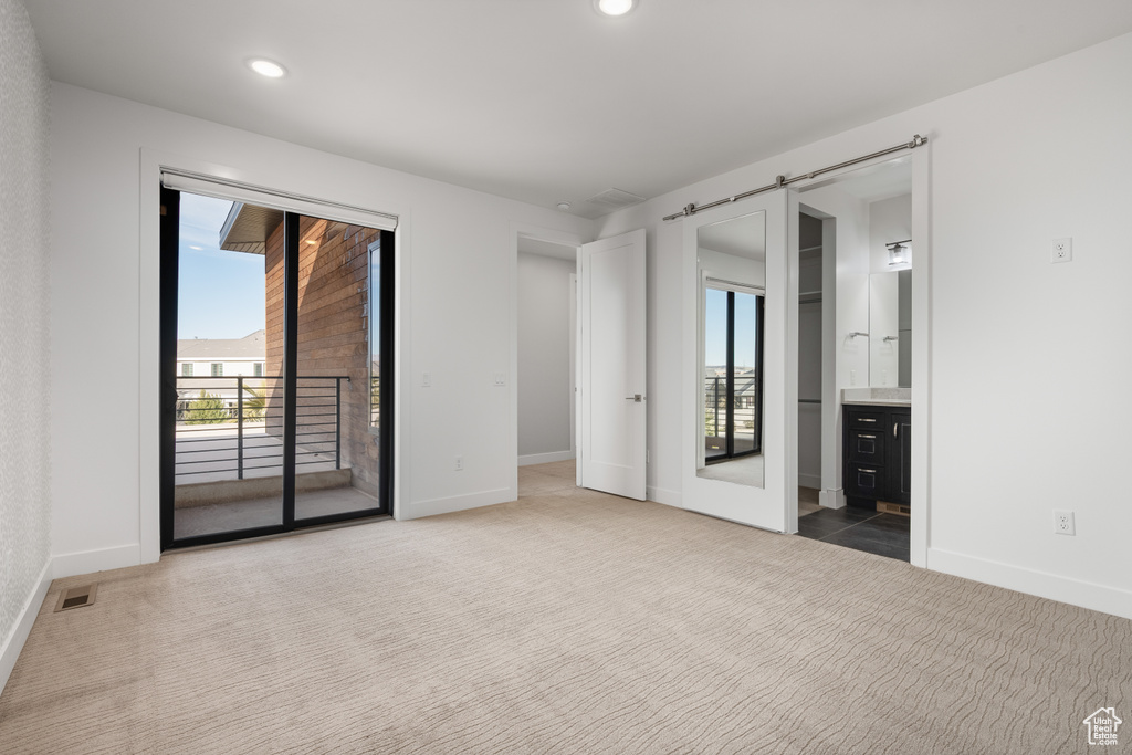 Unfurnished bedroom with access to outside, carpet, connected bathroom, and recessed lighting