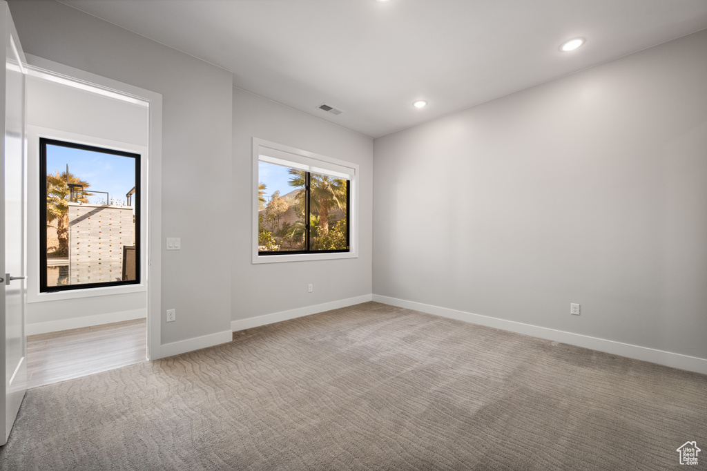 Carpeted spare room with recessed lighting
