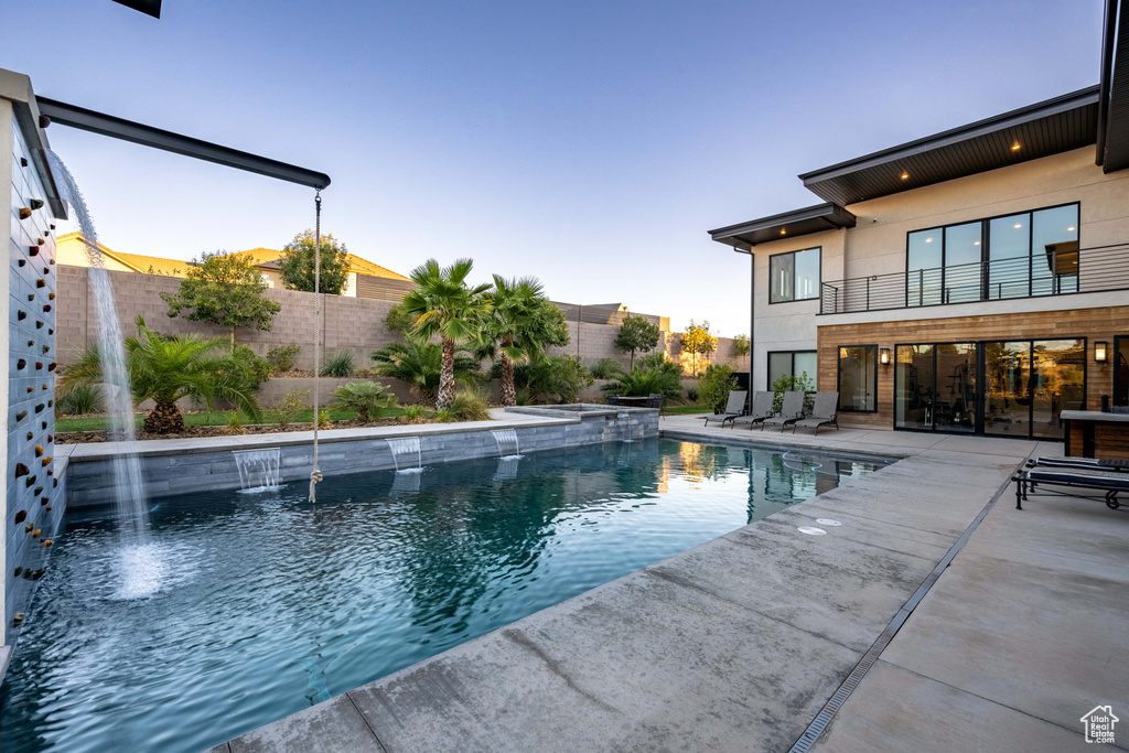 View of pool featuring a patio and a pool with connected hot tub