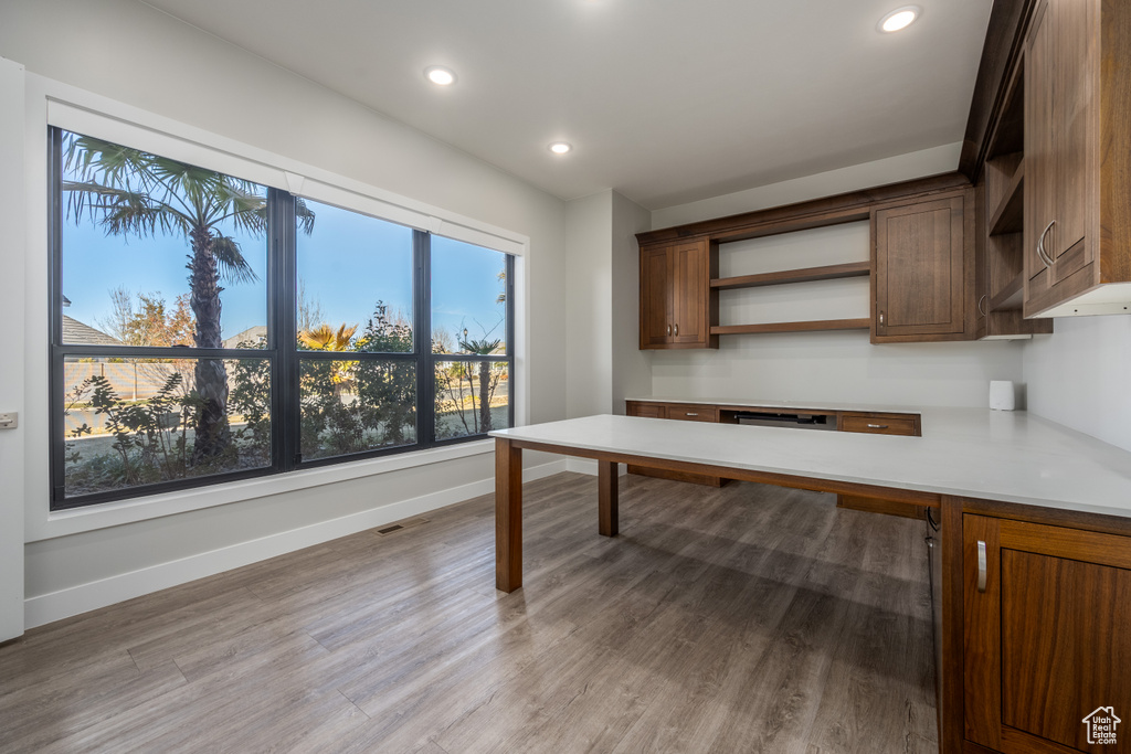Unfurnished office with light wood finished floors and recessed lighting