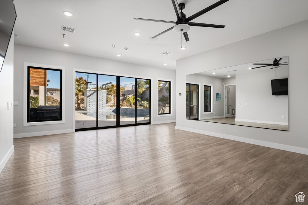 Unfurnished living room featuring ceiling fan, recessed lighting, and wood finished floors
