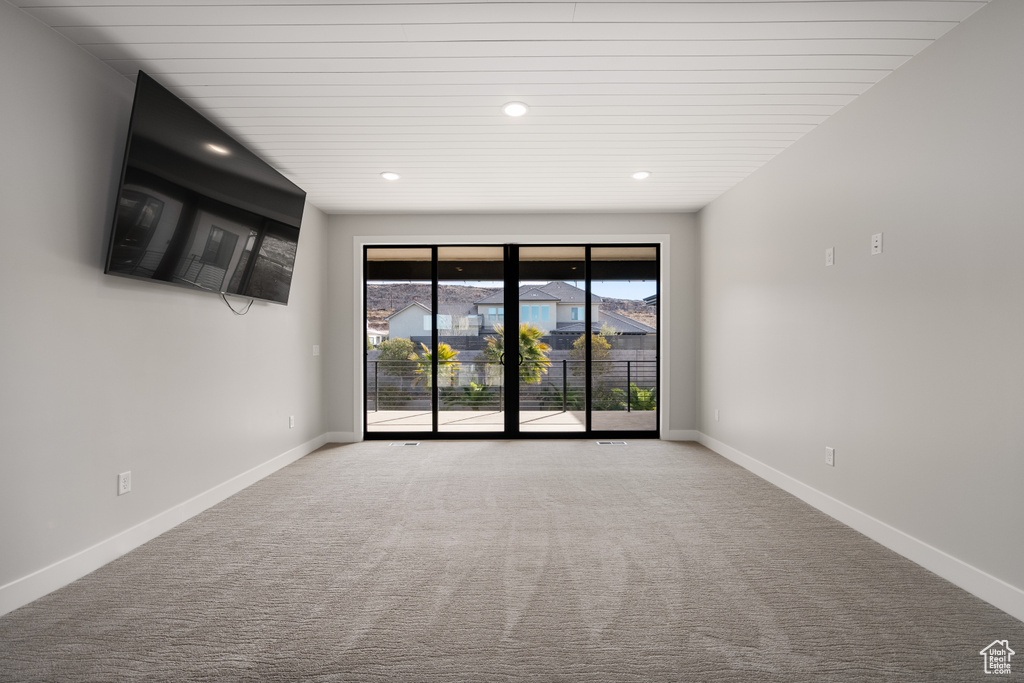 Carpeted empty room featuring recessed lighting