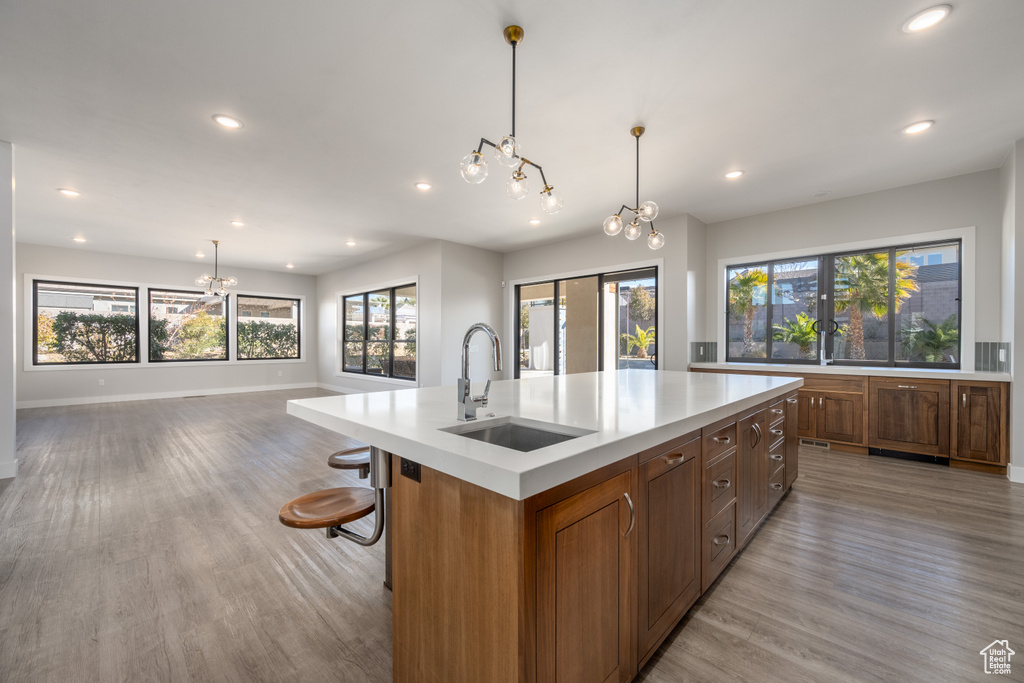 Kitchen featuring a chandelier, recessed lighting, light wood-style flooring, and plenty of natural light