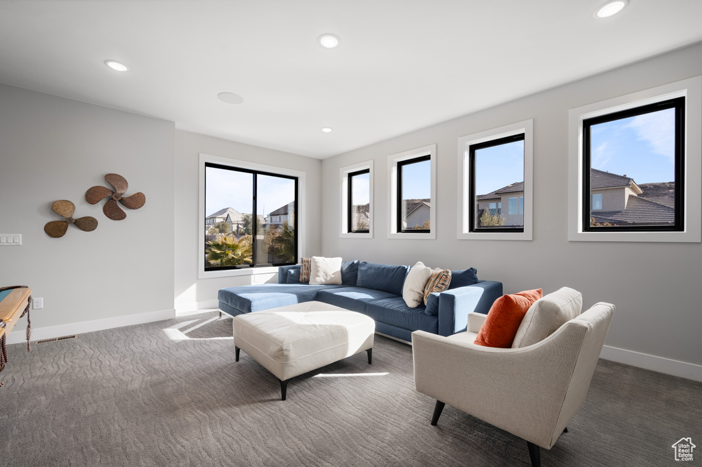 Carpeted living area with recessed lighting