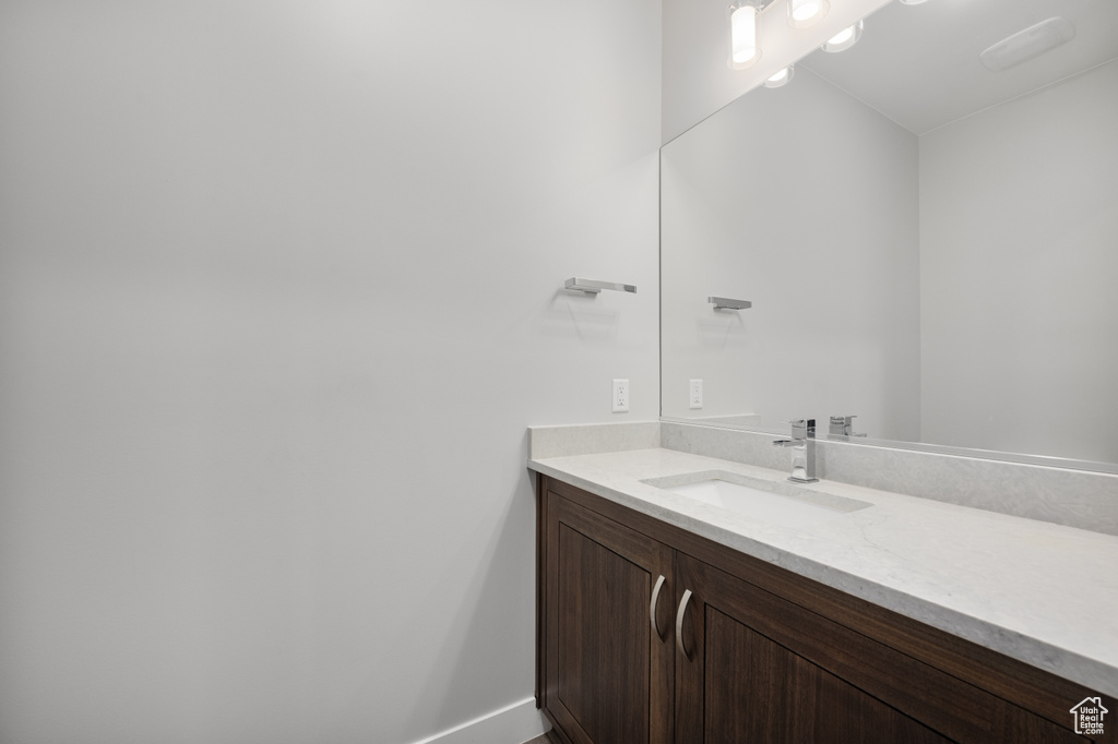 Bathroom with vanity and baseboards