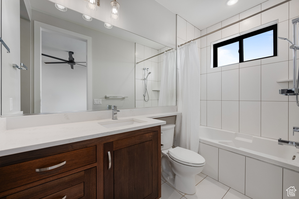 Full bathroom with vanity, shower / tub combo, a ceiling fan, and tile patterned floors