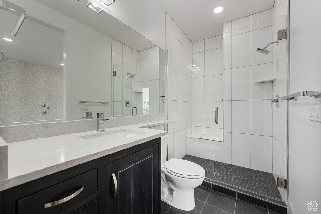 Full bath featuring vanity, tile patterned flooring, a shower stall, and recessed lighting