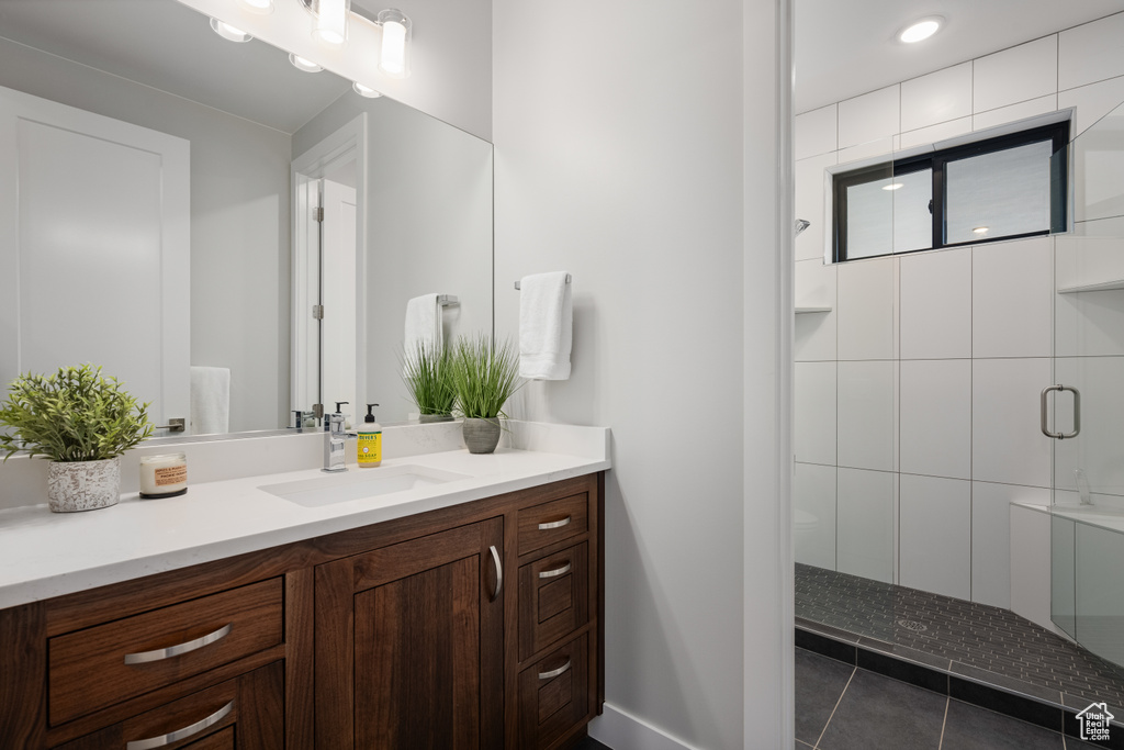 Bathroom featuring vanity and a tile shower