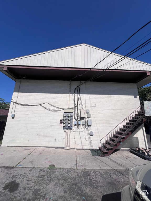 View of home's exterior featuring brick siding and stairway
