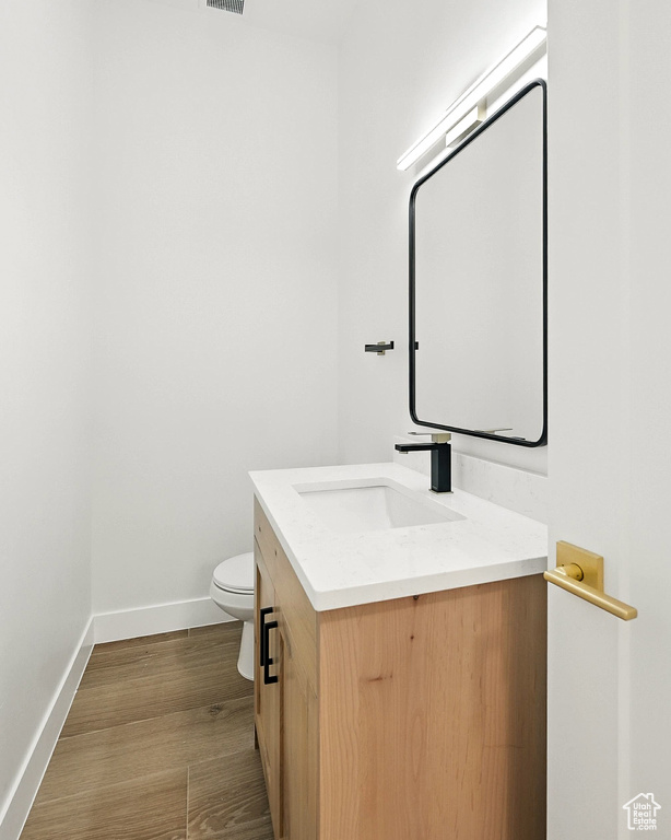 Bathroom with vanity and wood finished floors