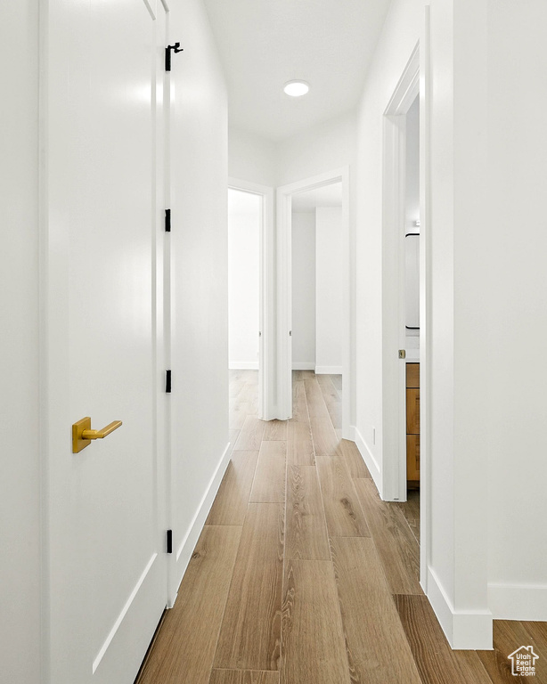 Corridor featuring wood finished floors and baseboards