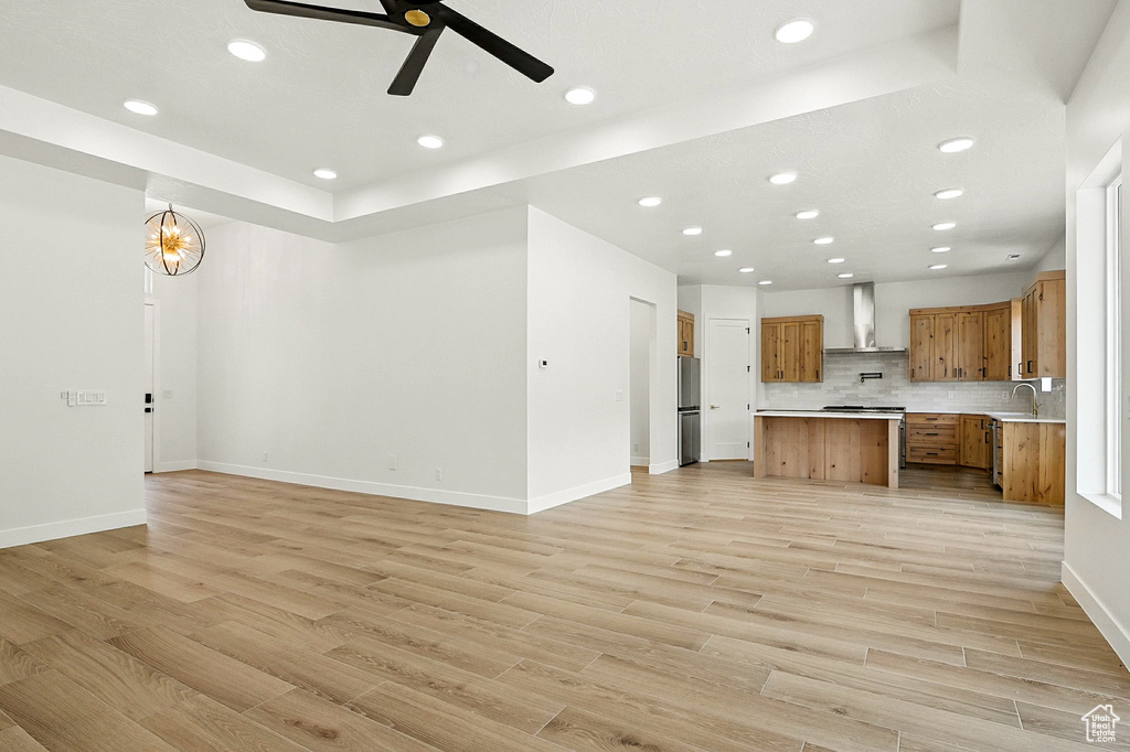 Unfurnished living room featuring light wood finished floors, recessed lighting, and ceiling fan